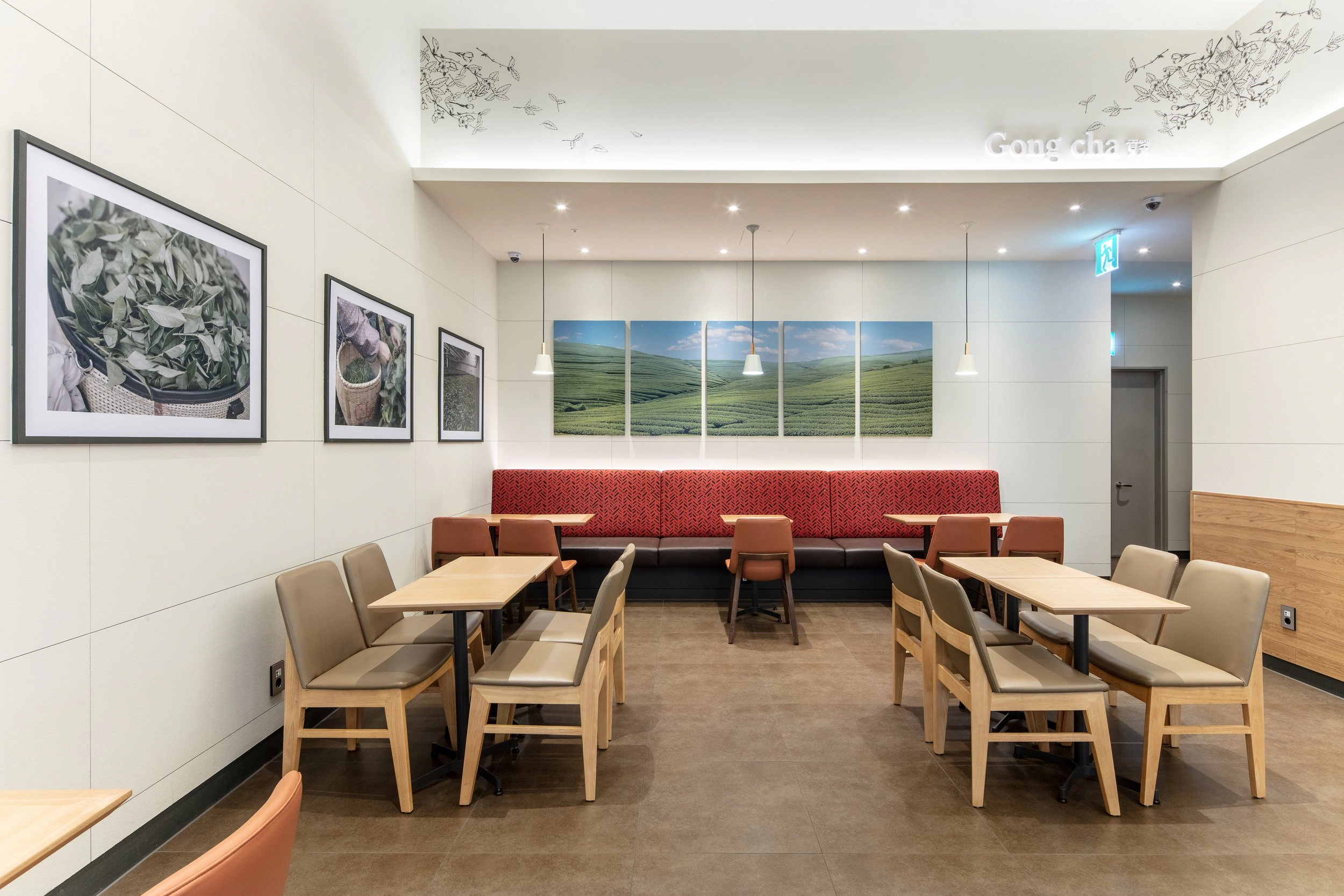 Dining area with Tea Red banquettes and tea-field artwork